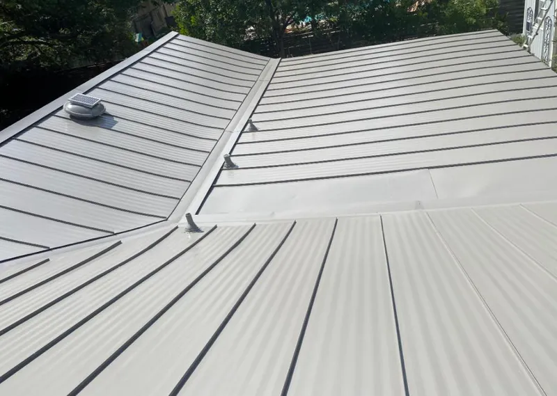 Solar attic fan installed on a metal roof for Roof Ventilation in Black Jack